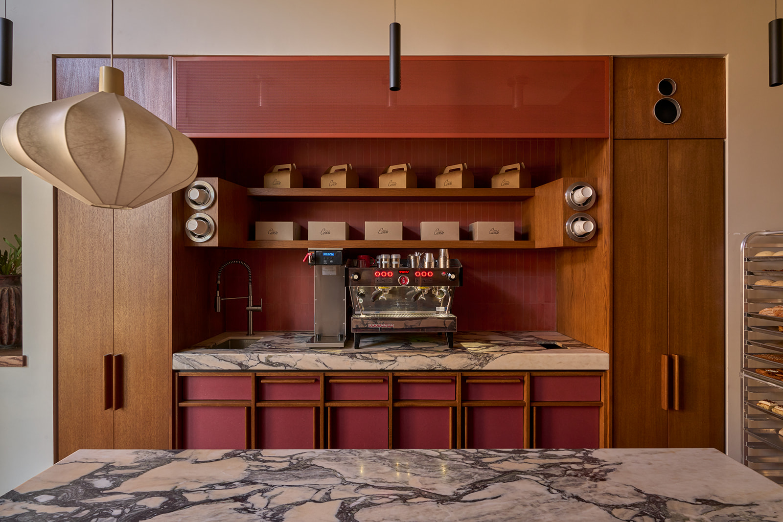Inside the Santa Canela bakery: the espresso bar under its paper lantern