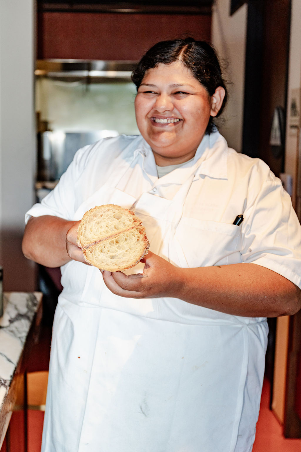 Ellen laughing with a loaf fresh from the oven