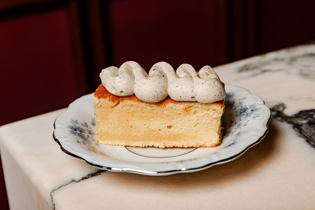 A slice of tres leches on a floral plate