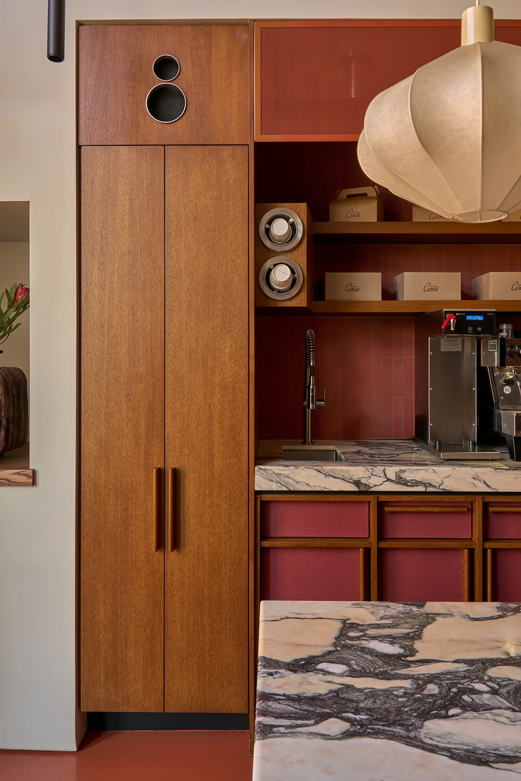 Warm oak cabinetry at the coffee bar